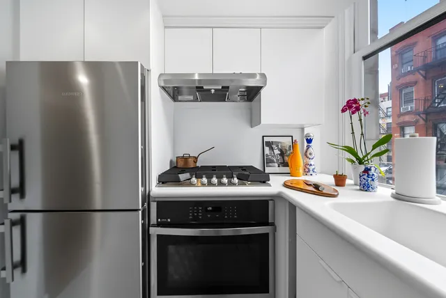 a kitchen with stainless steel appliances a refrigerator a stove and a sink