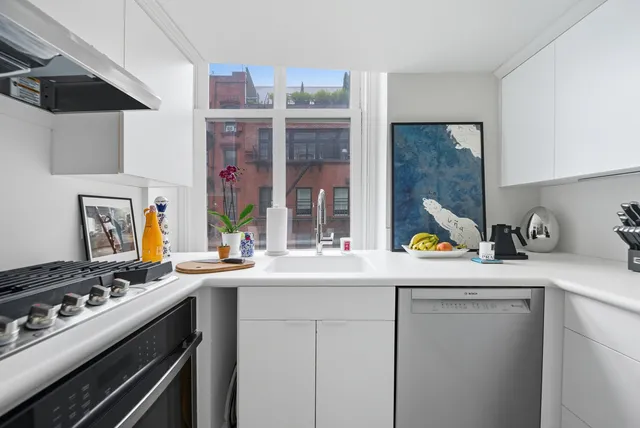 a kitchen with a sink a stove and cabinets