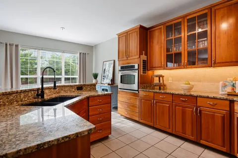 a kitchen with granite countertop a sink and cabinets