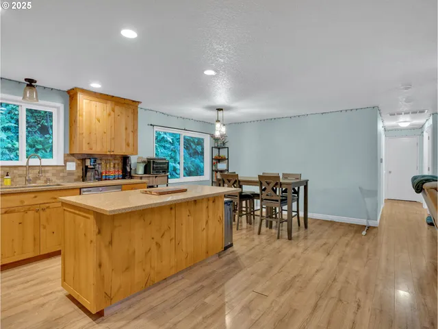 a kitchen with stainless steel appliances granite countertop a sink stove microwave and cabinets
