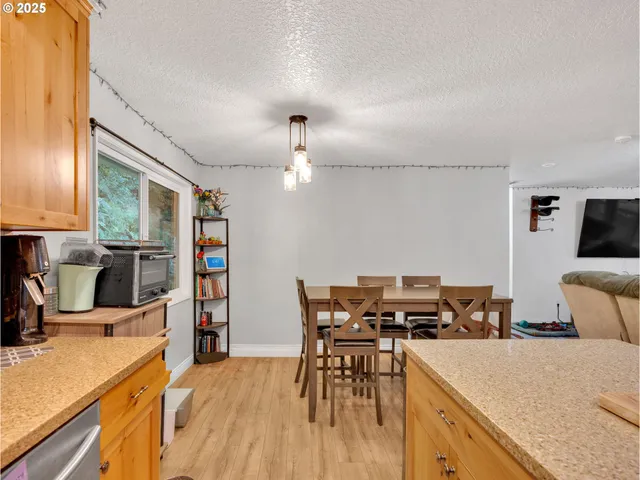 a kitchen with a table chairs stove and refrigerator