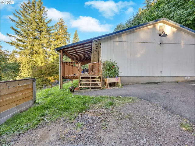 a backyard of a house with table and chairs
