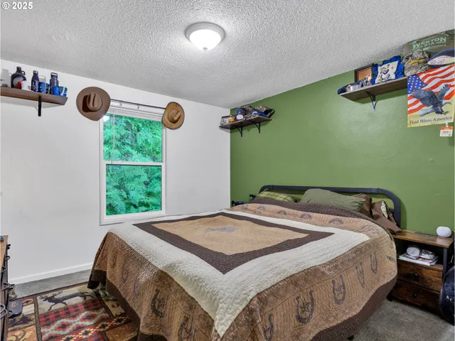 a view of a bedroom with workspace and toys