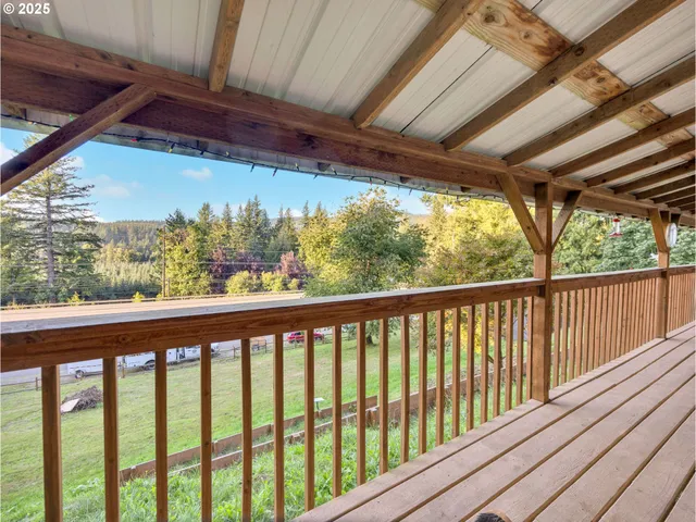 a view of balcony with chairs and wooden floor