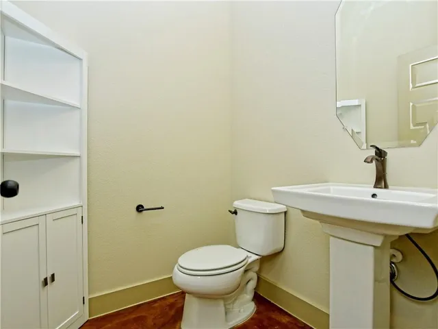a bathroom with a sink a toilet and mirror
