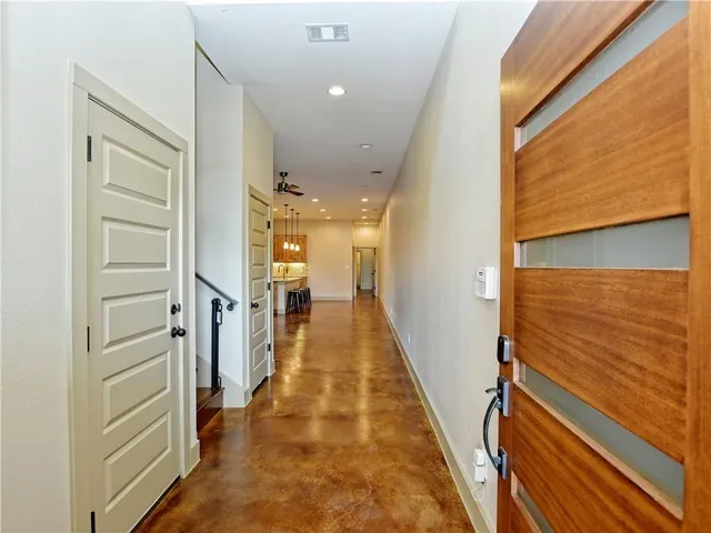 a view of room with walk in closet and wooden floor