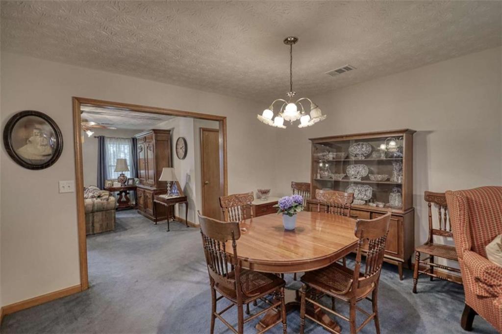 2740 Dennard Road Northeast Conyers, GA 30013 - Photo 11 of 51 a view of a dining room with furniture and chandelier