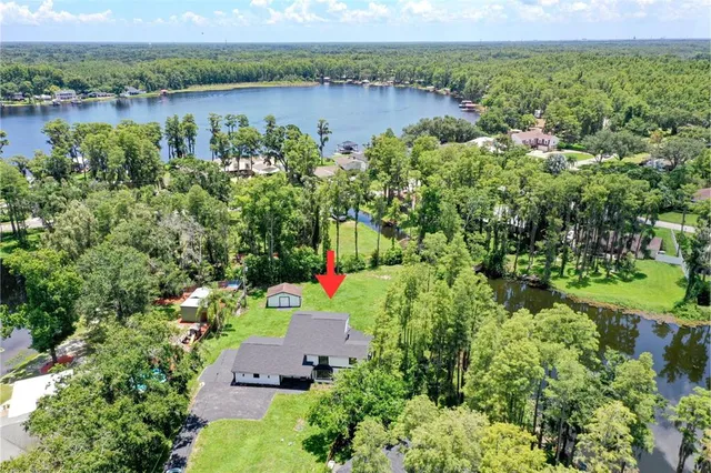 an aerial view of a houses with a lake view