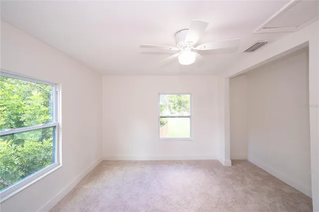 an empty room with a empty space and windows