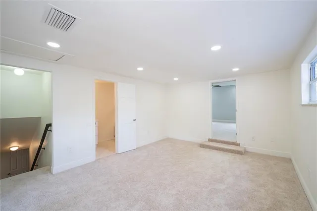 an empty room with windows and closet