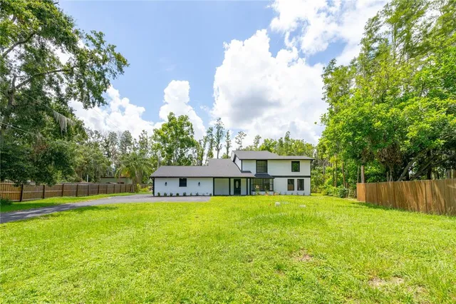 a view of a house with a yard