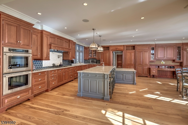 156 Overleigh Road Bernardsville, NJ 07924 - Photo 12 of 48 a kitchen with stainless steel appliances kitchen island granite countertop a stove top oven a sink a counter space and cabinets