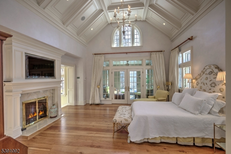 156 Overleigh Road Bernardsville, NJ 07924 - Photo 13 of 39 a spacious bedroom with a balcony a bed and a fireplace