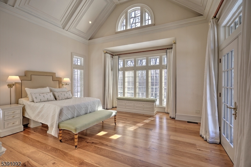 156 Overleigh Road Bernardsville, NJ 07924 - Photo 19 of 48 a spacious bedroom with a bed a dresser and wooden floor