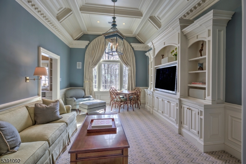 156 Overleigh Road Bernardsville, NJ 07924 - Photo 30 of 48 a living room with furniture a large window and a flat screen tv