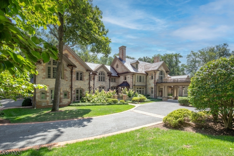 156 Overleigh Road Bernardsville, NJ 07924 - Photo 3 of 48 a front view of a house with a yard table and chairs