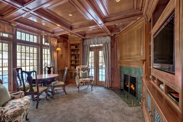 a dining hall with stainless steel appliances granite countertop a stove and cabinets with wooden floor