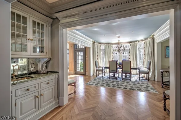 a kitchen with stainless steel appliances kitchen island granite countertop a stove top oven a sink a counter space and cabinets