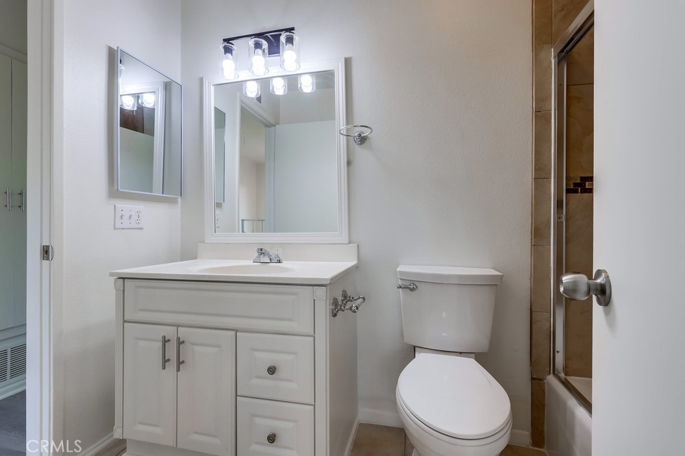 5429 Cajon Avenue Buena Park, CA 90621 - Photo 12 of 22 a bathroom with a toilet sink vanity and mirror