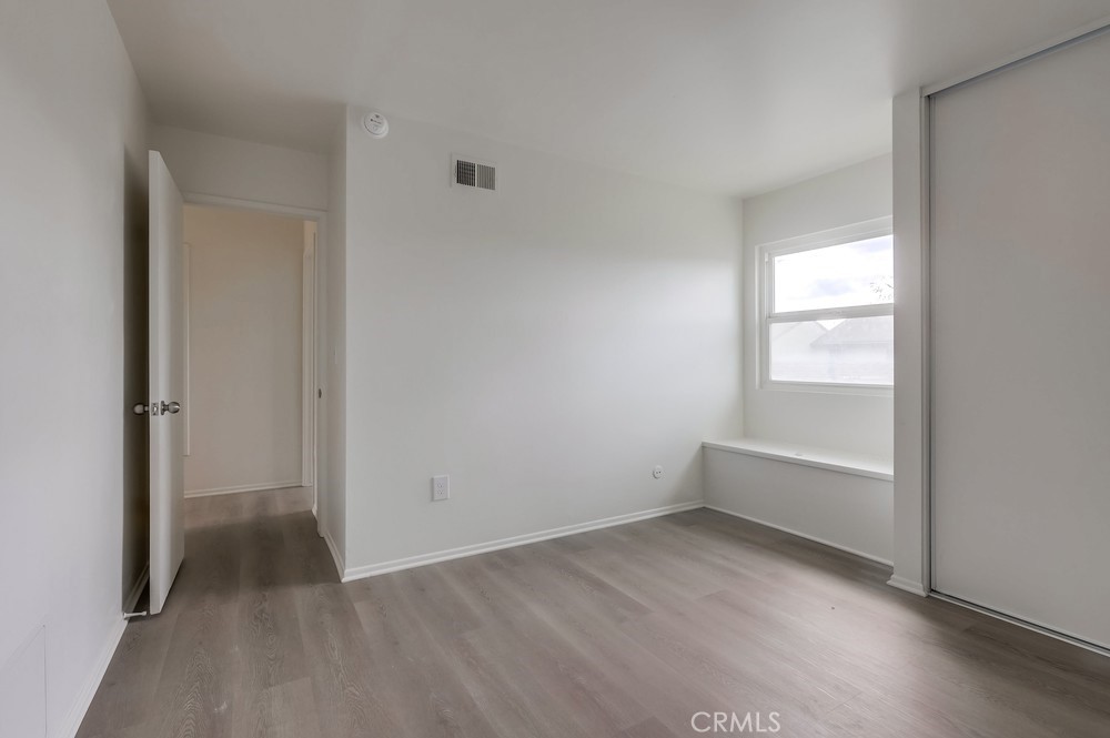 5429 Cajon Avenue Buena Park, CA 90621 - Photo 16 of 22 an empty room with wooden floor and windows