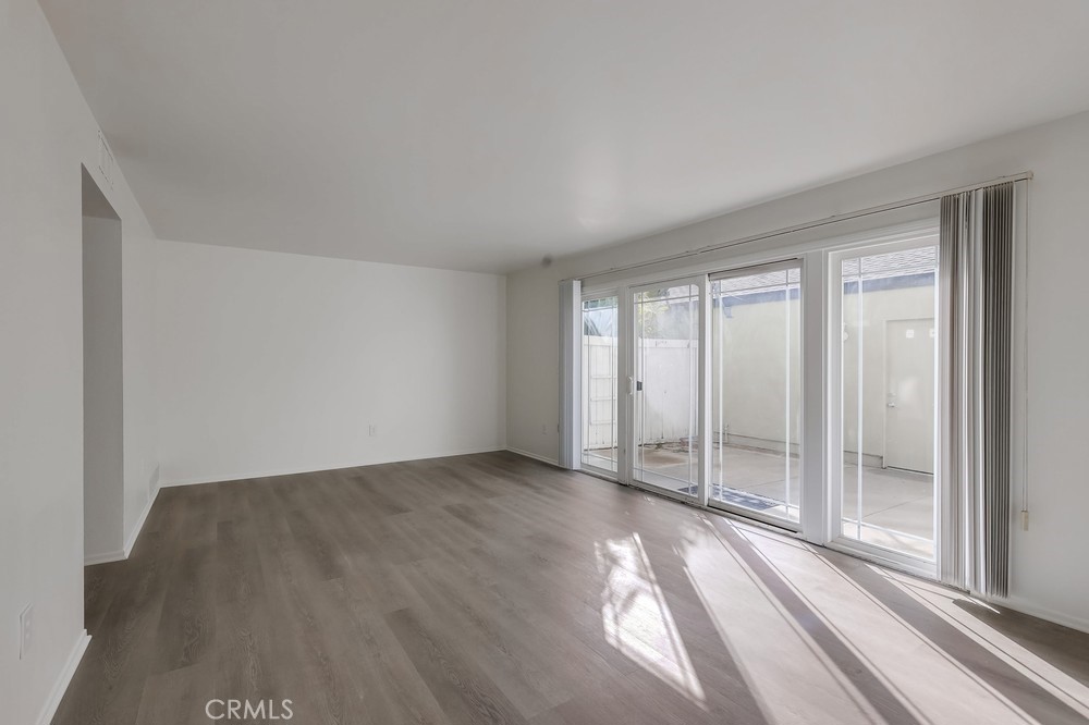 5429 Cajon Avenue Buena Park, CA 90621 - Photo 4 of 22 an empty room with wooden floor and windows