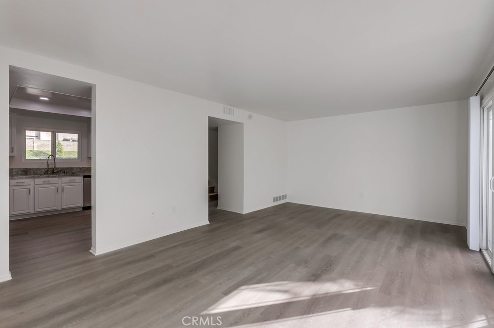 5429 Cajon Avenue Buena Park, CA 90621 - Photo 5 of 22 an empty room with wooden floor and windows