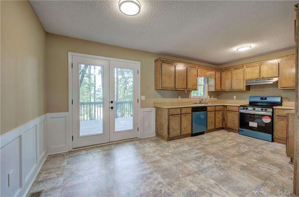 17 West Ridge Drive Southeast Cartersville, GA 30121 - Photo 11 of 37 a kitchen with stainless steel appliances granite countertop a stove sink and cabinets