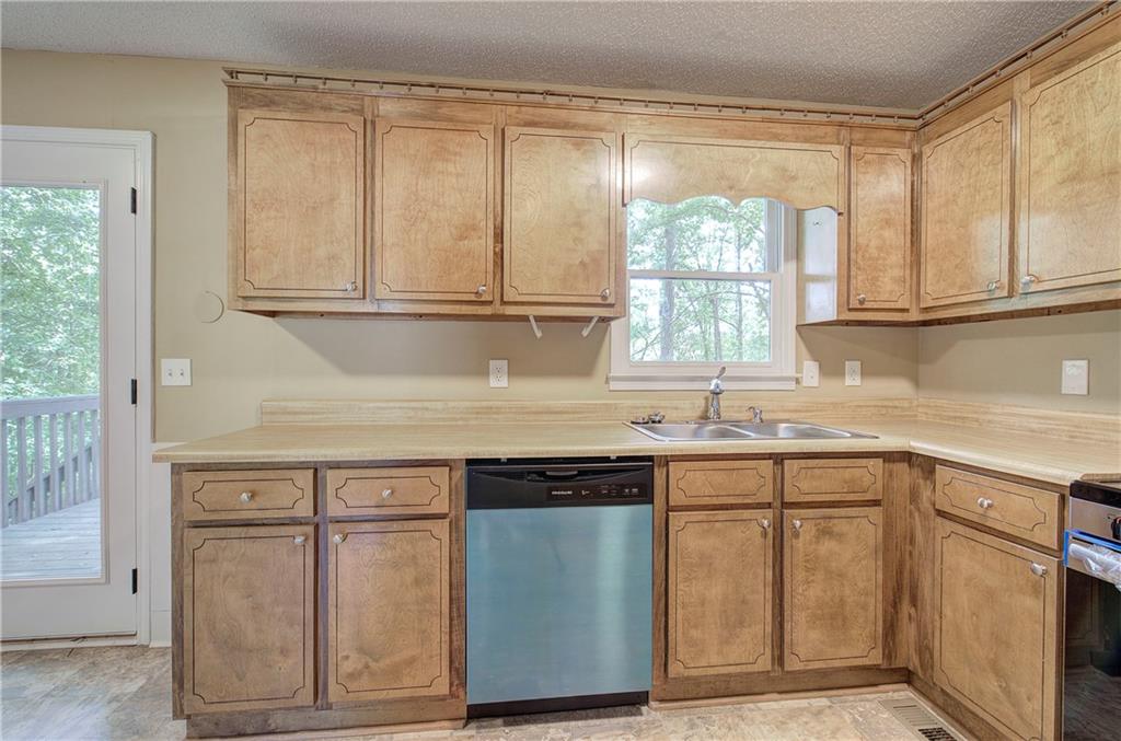 17 West Ridge Drive Southeast Cartersville, GA 30121 - Photo 13 of 37 a kitchen with stainless steel appliances granite countertop a sink and cabinets