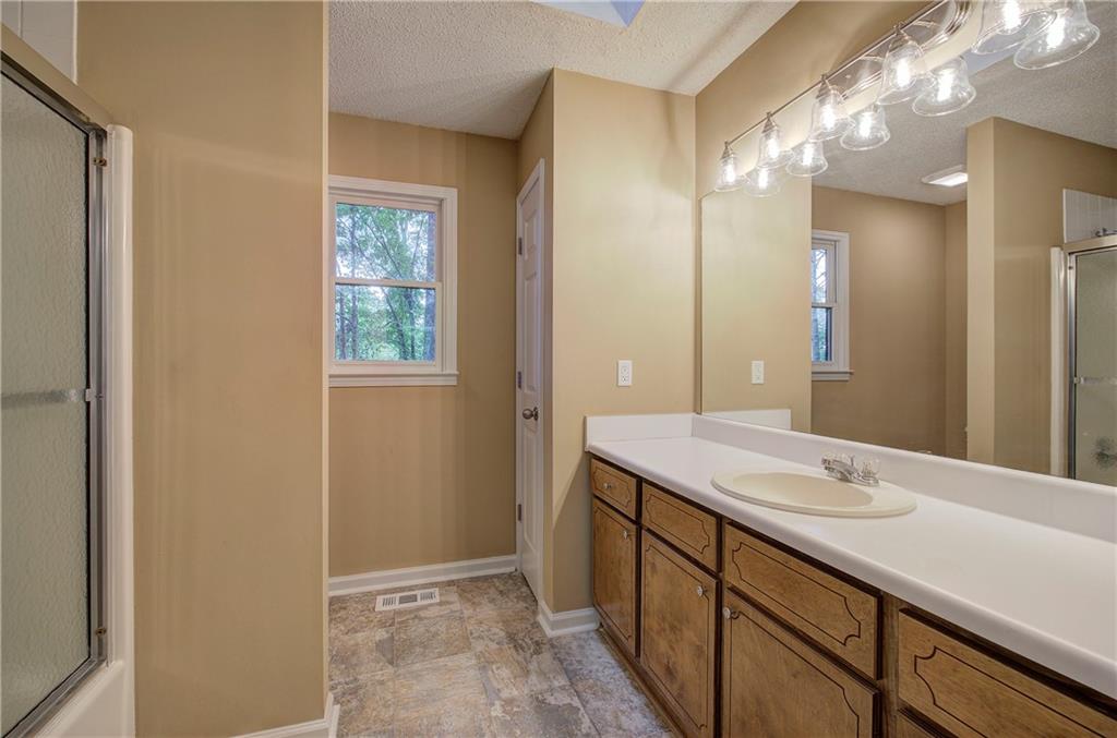 17 West Ridge Drive Southeast Cartersville, GA 30121 - Photo 18 of 37 a bathroom with a sink a vanity and a mirror