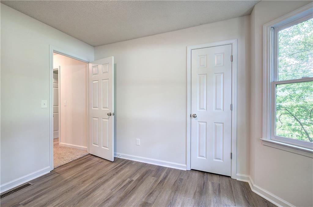 17 West Ridge Drive Southeast Cartersville, GA 30121 - Photo 22 of 37 an empty room with wooden floor and windows