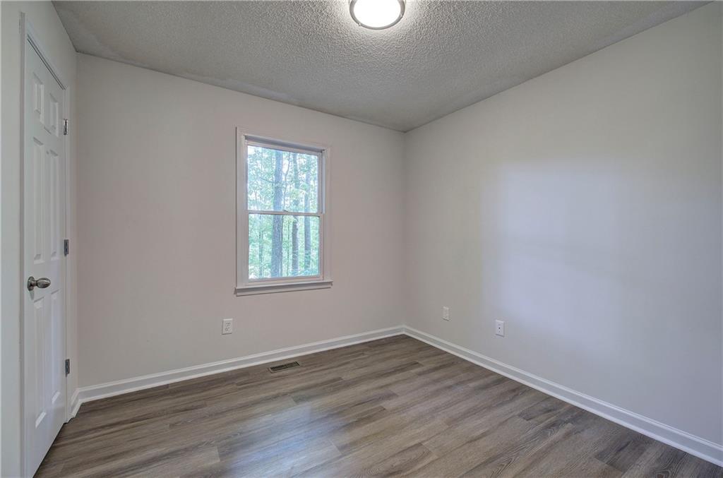 17 West Ridge Drive Southeast Cartersville, GA 30121 - Photo 23 of 37 wooden floor in an empty room with a window
