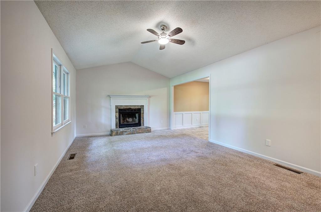 17 West Ridge Drive Southeast Cartersville, GA 30121 - Photo 7 of 37 an empty room with windows and fireplace