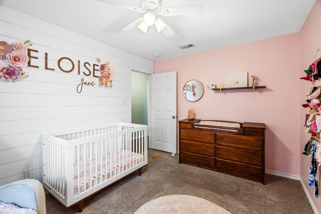 2302 Randi Road Rowlett, TX 75088 - Photo 18 of 33 a bedroom with a baby bed and a couch