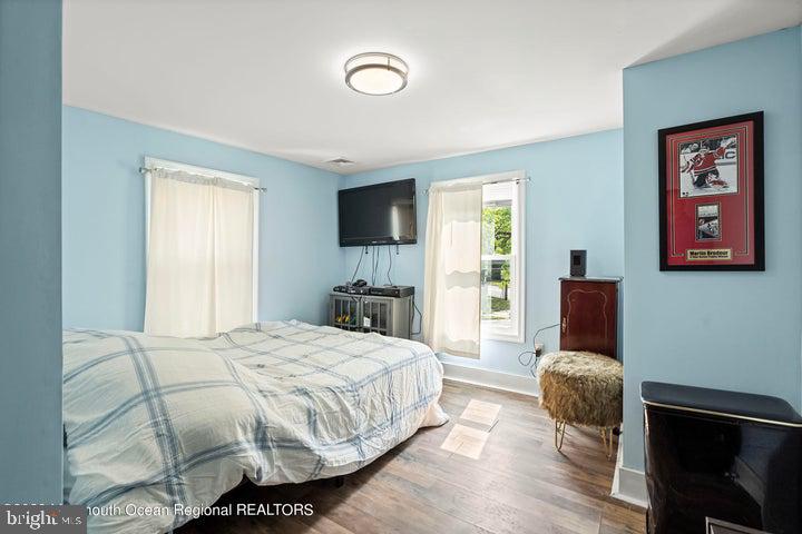 109 South Main Street Toms River, NJ 08757 - Photo 18 of 26 a bedroom with a bed and wooden floor