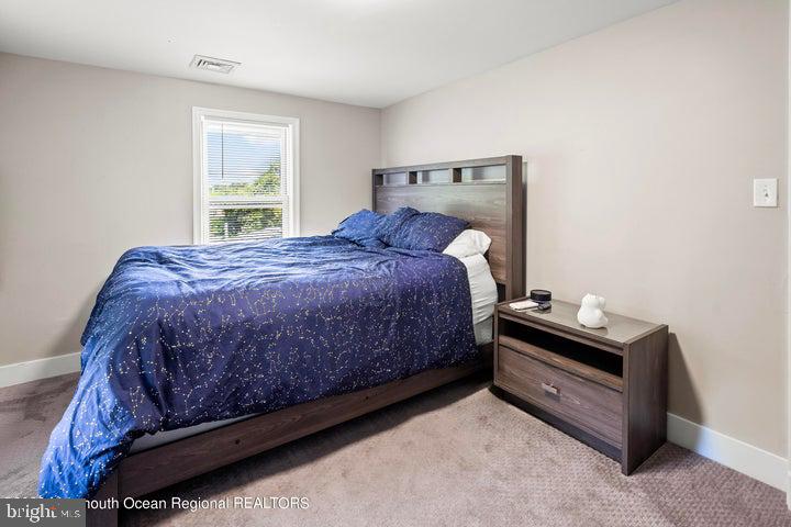 109 South Main Street Toms River, NJ 08757 - Photo 20 of 26 a bed sitting in a bedroom next to a window