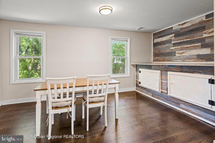 109 South Main Street Toms River, NJ 08757 - Photo 8 of 26 a kitchen with a table chairs a sink dishwasher window and cabinets