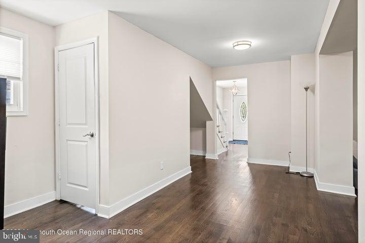 109 South Main Street Toms River, NJ 08757 - Photo 10 of 26 an empty room with wooden floor and windows