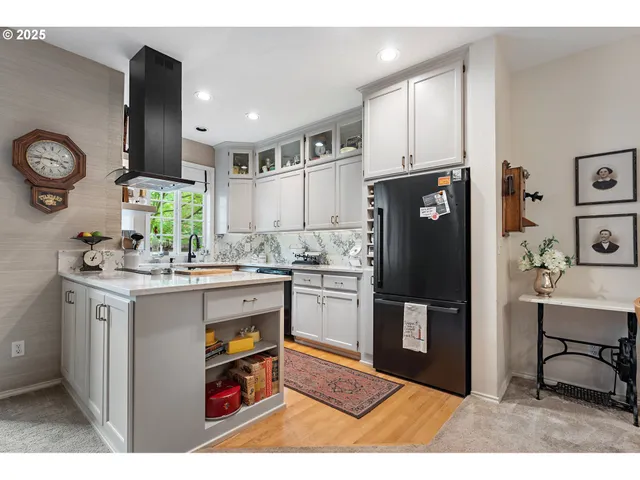 a kitchen with stainless steel appliances granite countertop a refrigerator and a stove
