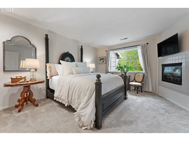 a bedroom with bed and a flat tv screen