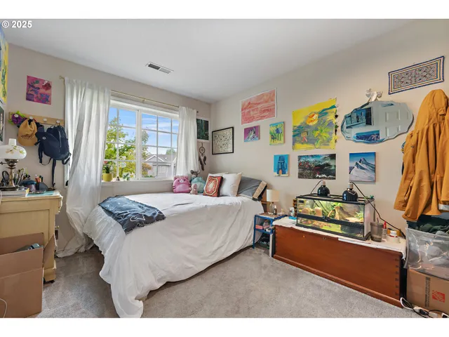 a bedroom with a bed and a dresser