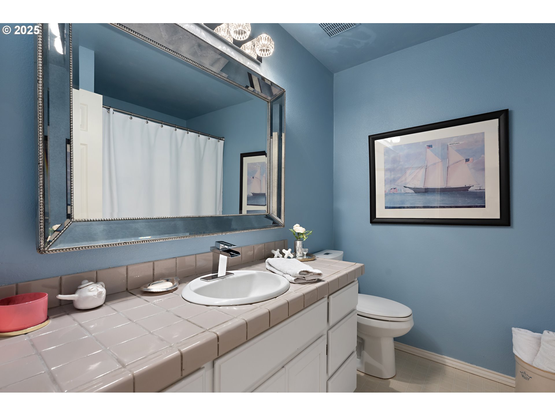 8200 Southwest Maxine Lane, Unit 59 Wilsonville, OR 97070 - Photo 26 of 33 a bathroom with a toilet sink and mirror