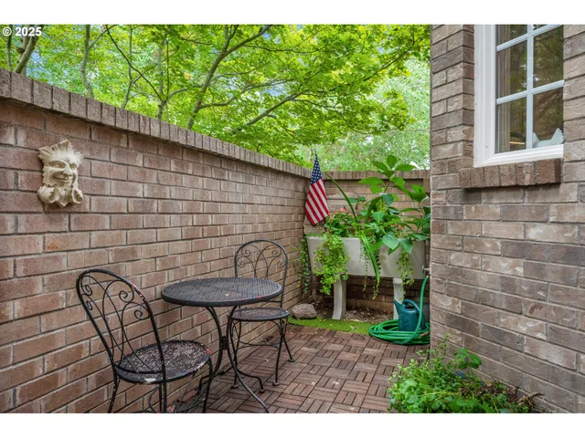 a backyard of a house with table and chairs