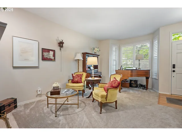 a living room with furniture and large windows