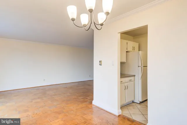 a view of a room with wooden floor and white walls