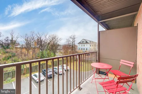 a view of a chairs and table in the balcony