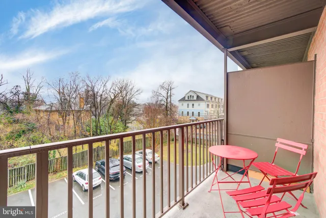 a view of a chairs and table in the balcony