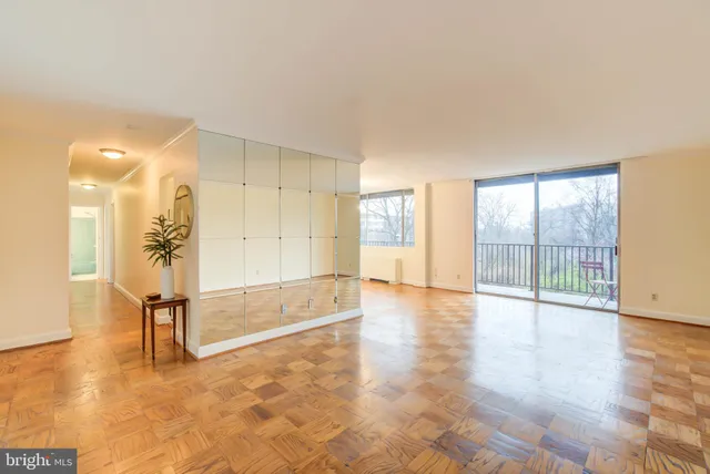 a view of an empty room with glass door
