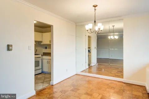 a view of a kitchen and a chandelier fan