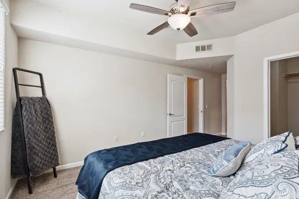 a bedroom with a bed and a chandelier