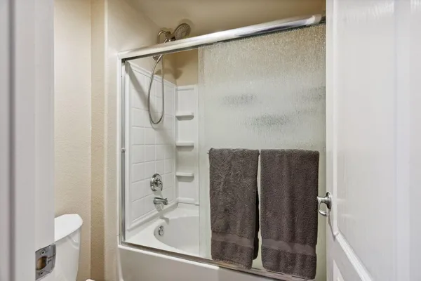 a bathroom with a shower and a bath tub